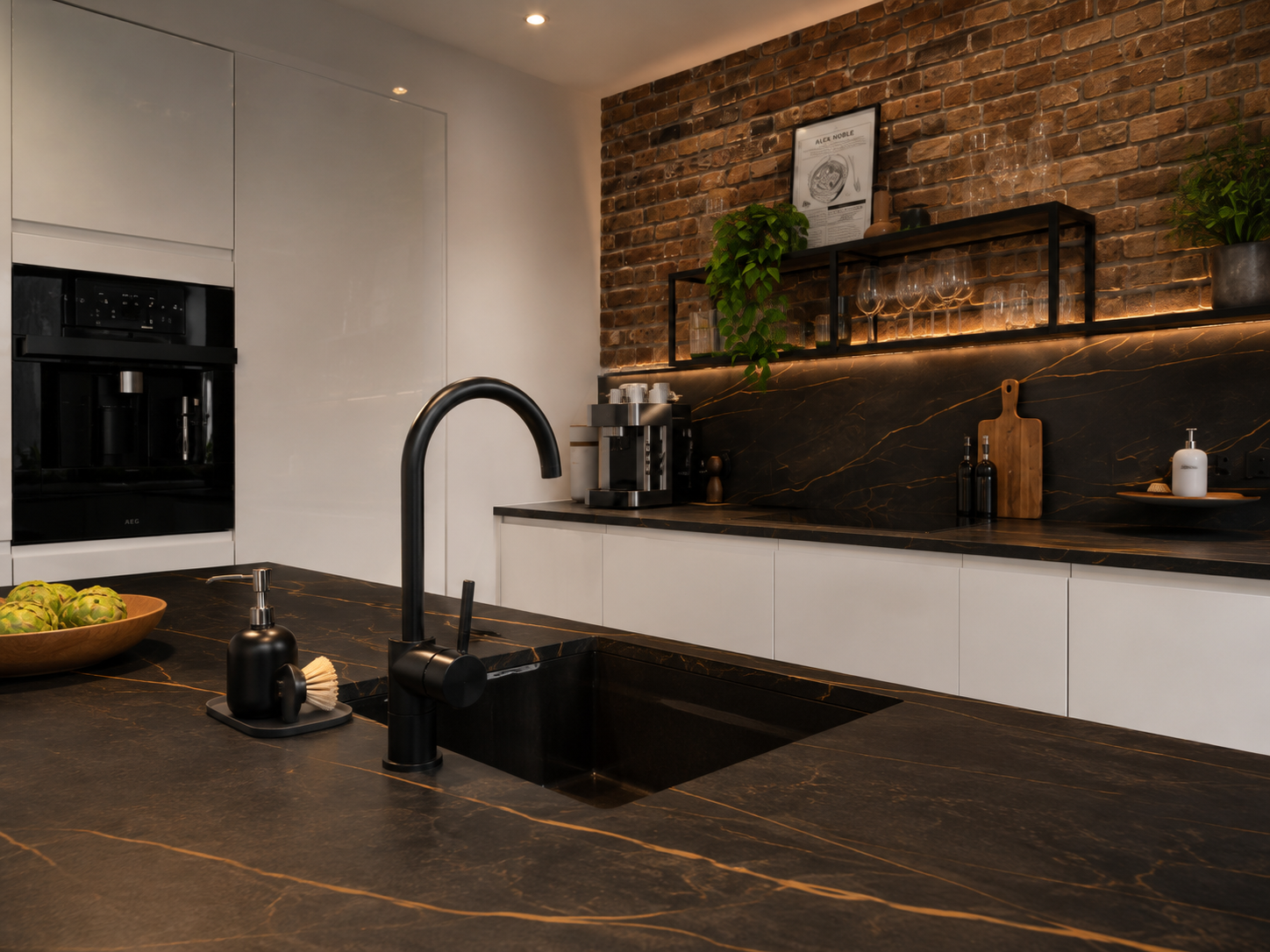 Loft bespoke kitchen with dark stone worktop and brick wall — Dominus Kitchens