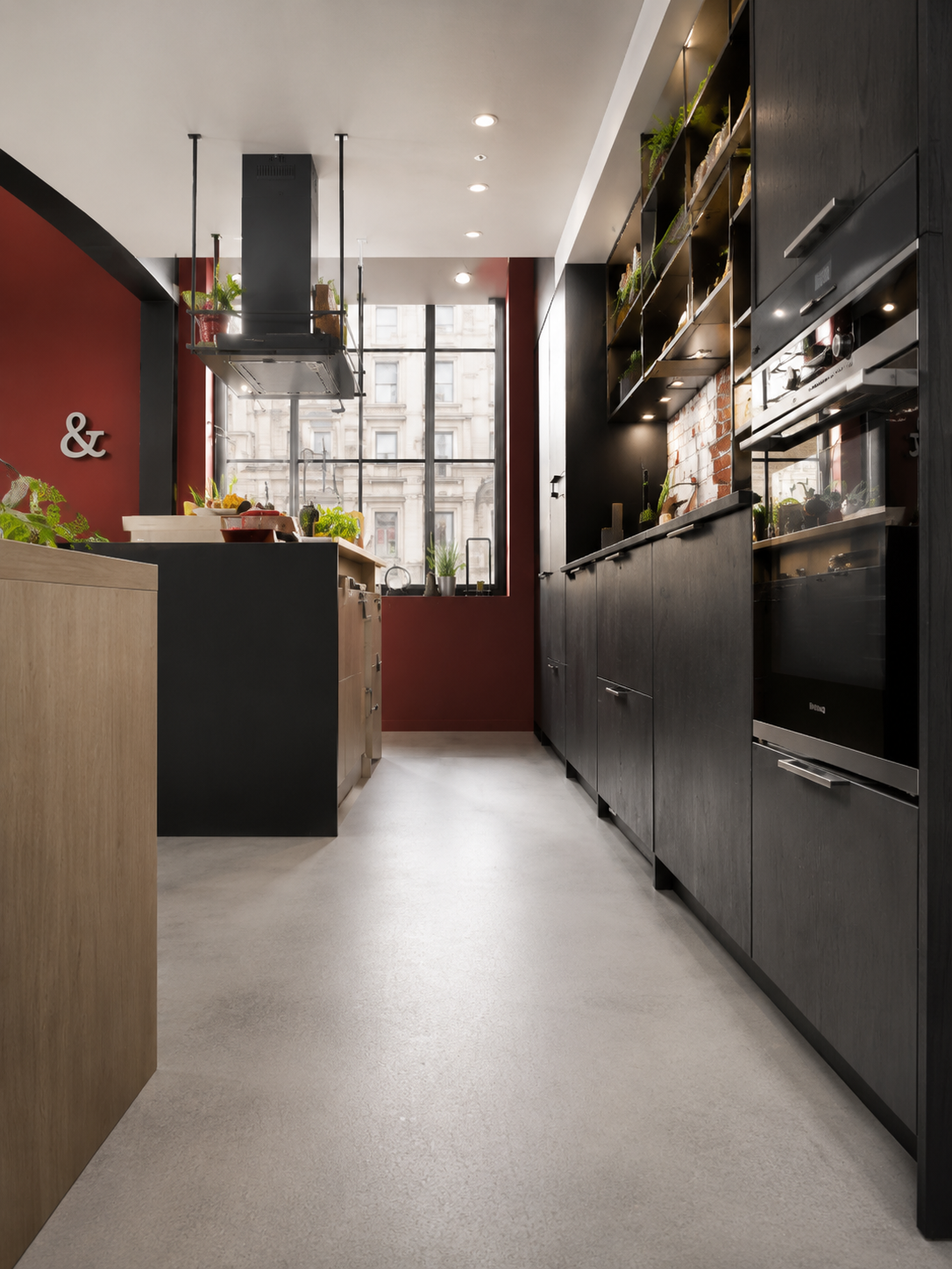 Dark corridor pantry with oxblood joinery and long sight-line — Dominus Kitchens London — Dominus Kitchens London — Oxblood — Dominus Kitchens Bespoke Kitchens London | Dominus Kitchens London